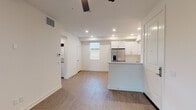 Located at 3310 W 84th St in Inglewood, CA, this single-floor unit offers a clean, modern aesthetic throughout. The open-concept living and kitchen area is bright and airy, featuring wood-style luxury flooring, recessed lighting, and a ceiling fan. The kitchen is well-appointed with white shaker cabinetry, light quartz countertops, a peninsula with an integrated sink, and a full suite of stainless steel appliances including a refrigerator, electric range, and over-the-range microwave. Natural light filters in through slatted blinds, enhancing the crisp, neutral color palette of the space. The bedrooms are carpeted and comfortably sized, each featuring ceiling fans, generous windows with outdoor views, and mirrored sliding closet doors. One bedroom also includes access to a dedicated walk-in closet. The bathrooms are finished with wood-style flooring and clean white fixtures; one features a full tub-shower combination with subway tile surround and brushed nickel hardware, while the second offers a more compact layout with a vanity. An in-unit stacked washer and dryer is conveniently located within the living area. The overall design is cohesive and contemporary, delivering a functional and comfortable living environment.