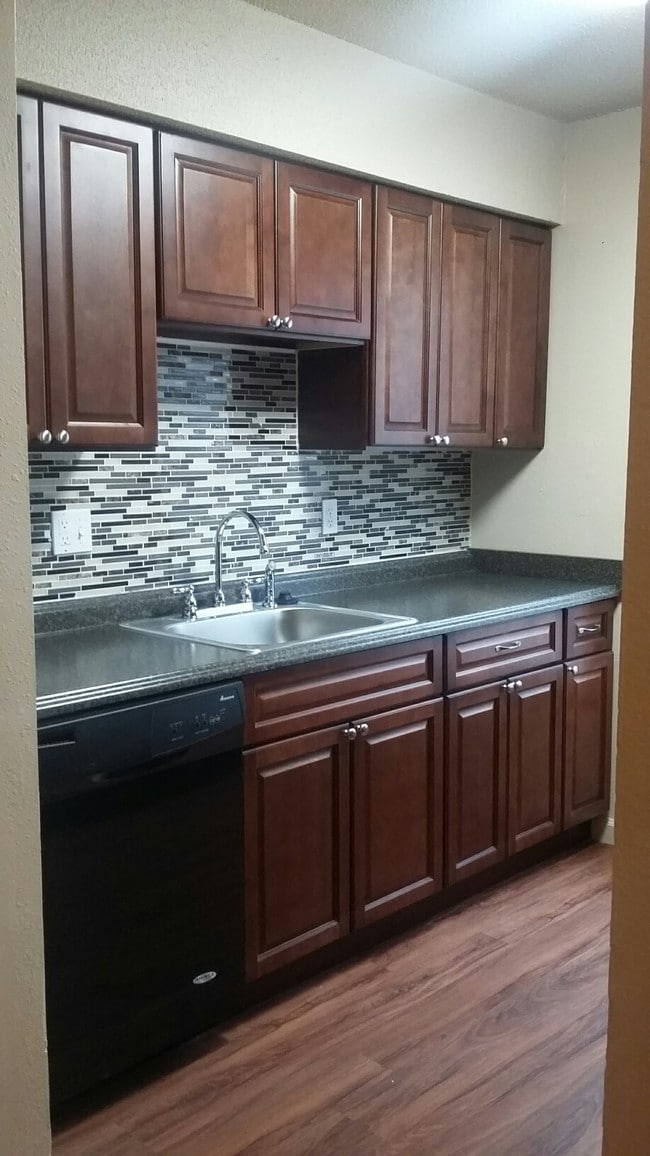 Tile Backsplashes and Cinnamon Oak Cabinetry - Steeple Club Apartments