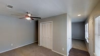 Located in Garland, this single-story home offers a straightforward and functional layout designed for comfortable everyday living. The interior is finished with neutral, warm-toned walls throughout, creating a clean and versatile backdrop that suits a variety of décor styles. The bedroom features soft wall-to-wall carpeting underfoot, providing warmth and comfort, while a ceiling fan with integrated lighting ensures year-round climate comfort. A set of louvered bi-fold closet doors offers convenient built-in storage, keeping the room organized and uncluttered. White trim and baseboards provide a crisp contrast against the taupe-toned walls, lending the space a tidy, well-maintained appearance. Adjacent areas of the home transition to hard-surface flooring, adding visual variety and practicality to the overall layout. The single-floor design ensures easy accessibility throughout, making it a highly functional living environment. Overall, the home presents a move-in-ready condition with a clean, neutral palette that provides an excellent foundation for personalization.