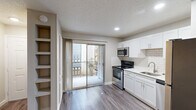 Located at 2121 Dickson Drive in Austin's vibrant 78704 neighborhood, this efficiently designed studio unit offers a well-planned single-floor layout that maximizes every square foot. Wood-look flooring flows throughout the space, complemented by neutral-toned walls, white baseboards, and a textured ceiling that adds subtle character. The open living area features a ceiling fan with light fixture and HVAC vents for year-round comfort, with a window allowing natural light to fill the room.

The kitchen is a standout feature, thoughtfully equipped with white shaker-style cabinetry, a white subway tile backsplash, light countertops, and a full suite of stainless steel appliances — including a refrigerator, range, microwave, and dishwasher. A single-basin sink with a brushed nickel faucet and built-in open shelving add both function and style. Sliding glass doors lead directly from the kitchen to a private balcony, bringing in abundant natural light and outdoor access.

The bathroom includes a tiled tub-and-shower combination with a curtain rod, a toilet, and wood-look flooring that ties into the rest of the unit. A dedicated closet provides practical storage. This clean, updated studio is an ideal option for those seeking a functional, modern living space in one of Austin's most sought-after neighborhoods.