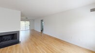 Located at 835 Westridge Dr in Phoenixville, PA, this well-appointed 2-bedroom, 3-bathroom home offers a thoughtfully designed layout across a single floor. The bright living room features light hardwood-style flooring, clean white walls, and a classic black-surround fireplace, creating a warm and inviting focal point. A staircase leads to additional areas, adding vertical dimension to the space. The galley-style kitchen is well-equipped with gray shaker cabinetry, dark granite countertops, stainless steel appliances including a refrigerator, electric range, and microwave, all set over matching hardwood-style flooring. Both bedrooms are carpeted and filled with natural light from large windows that offer views of the surrounding greenery. Each bedroom includes closet storage, with the primary bedroom featuring both a walk-in-style closet and an additional open wardrobe niche. The bathrooms are finished with gray vanity cabinetry and tile flooring. A dedicated laundry room with full-size washer and dryer adds everyday convenience. Outside, the property sits within a well-maintained, tree-lined community with manicured lawns and mature landscaping, offering a peaceful residential atmosphere.