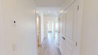 Located at 14009 28 Avenue SW in Edmonton, Alberta, this well-appointed 2-bedroom, 3-bathroom residence offers a thoughtfully designed single-floor layout with a clean, contemporary aesthetic throughout. Light-toned hardwood-style flooring flows seamlessly through every room, complementing the bright, neutral palette of warm white walls and crisp trim.

The open-concept kitchen and living area serves as the heart of the home, featuring white shaker-style cabinetry, a subway tile backsplash, a central island with an integrated sink, and a full suite of stainless steel appliances. Recessed lighting and a wall-mounted air conditioning unit add both functionality and a modern touch. The living area extends toward a glass-railed balcony, offering pleasant views of the surrounding landscaped neighborhood.

The bedrooms are generously proportioned, each filled with natural light through large windows overlooking the street and greenery outside. The primary bedroom offers a comfortable retreat with access to its own dedicated bathroom. The three bathrooms are finished in a consistent modern style, with one featuring a full soaker tub and shower combination with clean white tile surround. A dedicated closet provides additional storage. Baseboard heating runs throughout, ensuring year-round comfort in this efficiently designed home.