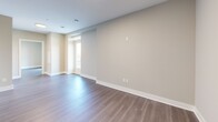 Located on the 18th floor at 195 Dundas St in downtown London, Ontario, this modern one-bedroom, one-bathroom unit offers a well-designed layout with contemporary finishes throughout. The open-concept kitchen is a standout feature, equipped with stainless steel appliances including a French door refrigerator, electric range, and built-in microwave. Crisp white cabinetry with subway tile backsplash and a large central island with a quartz countertop provide ample prep and storage space, while warm-toned laminate flooring ties the space together seamlessly. The living area is bright and open, with neutral walls and large windows that invite natural light and frame expansive views of the London cityscape. The bedroom is comfortably sized, featuring a large double-door closet, laminate flooring, and a floor-to-ceiling window overlooking the city below. The bathroom is finished with large-format tile flooring, a marble-accented tub surround, a modern vanity, and elegant accent lighting. A private balcony accessed through glass sliding doors offers stunning panoramic views of the London skyline and surrounding cityscape — a rare highlight at this elevation. The overall aesthetic is clean, contemporary, and move-in ready.