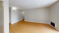Located at 8717 Riverside Dr E in Windsor, Ontario, this well-appointed two-bedroom, one-bathroom unit offers a clean and functional layout designed for comfortable everyday living. Light hardwood flooring flows consistently throughout the space, complementing the neutral grey-toned walls and crisp white trim found in every room.

The combined living and dining area serves as the heart of the unit, featuring a sliding glass door that opens directly onto a private balcony with outdoor views of the surrounding neighbourhood. A wall-mounted heating unit ensures year-round comfort in this bright, open space.

The kitchen is efficiently designed with white cabinetry extending to the ceiling, grey countertops, a stainless steel sink, and a full suite of stainless steel appliances including a refrigerator, electric range, and microwave. Light from the main living area carries naturally into this space.

Both bedrooms feature the same warm hardwood flooring and soft neutral walls. The primary bedroom includes a large sliding-door closet for generous storage, while the second bedroom benefits from a bright window with neighbourhood views. The bathroom offers a vanity with a wide mirror, grey countertop, and clean white finishes throughout.