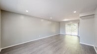 This two-story residence offers a practical and well-organized layout, with living spaces distributed across two floors. The main level features a bright living room finished with durable wood-look flooring, recessed lighting, and sliding glass doors that invite natural light and provide access to an outdoor area. A front entry area with a large window further enhances the sense of openness. The kitchen is efficiently designed with gray cabinetry, white countertops, a tile backsplash, and white appliances including a gas range and full-size refrigerator, with direct access to an exterior door. A full bathroom on the main level includes a tub/shower combination and a vanity with ample counter space. Upstairs, two carpeted bedrooms each feature ceiling fans with light fixtures, closets for storage, and windows that allow natural light to filter in. The primary bedroom offers a generous footprint with a dedicated closet. The second full bathroom mirrors the clean, neutral aesthetic found throughout the home. Soft gray tones, white trim, and consistent flooring choices create a cohesive and move-in-ready environment throughout this well-maintained two-floor residence.