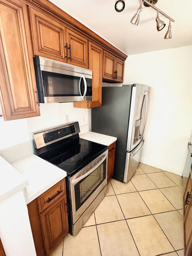 Kitchen Stainless steel microwave, stove, and fridge - 2507 E 15th St