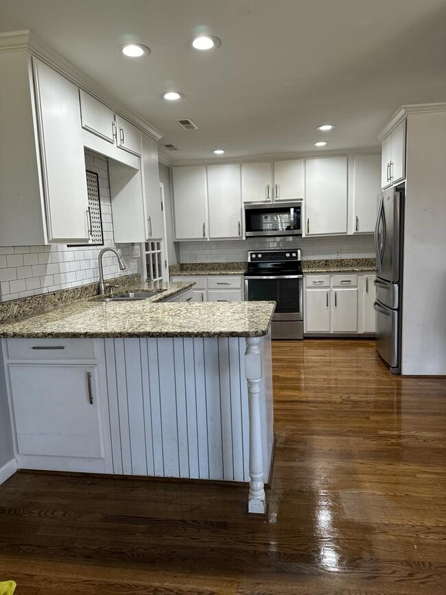 Kitchen, granite countertops, tile backslash, stainless steel appliances, under cabinet lighting - 2714 Leo Dr