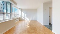 Located at 100 Roehampton Ave in Toronto's Midtown neighbourhood, this efficiently designed studio unit offers a well-considered layout across a single floor. The bright living area is a standout feature, showcasing classic parquet wood flooring in a herringbone pattern and large windows that flood the space with natural light while framing views of the surrounding Toronto skyline. A private balcony extends the living space outdoors, offering an additional vantage point over the city.

The kitchen is outfitted with rich dark wood cabinetry, white quartz countertops, a white tile backsplash, a stainless steel sink with a modern faucet, and an electric range — providing a functional and stylish cooking space. Two closets offer practical storage solutions within the unit.

The bathroom features distinctive dark marble-style tile flooring, a sleek vanity with a white countertop and dark wood cabinetry, a mirrored medicine cabinet, and a full bathtub with tiled surround, creating a clean and contemporary feel. The entrance area transitions smoothly into the main living space, completing a cohesive and practical floor plan well-suited for city living.