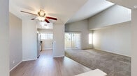 Located at 3644 Kings Way in Sacramento, CA, this well-appointed one-bedroom, one-bathroom unit offers a thoughtfully designed single-floor layout. The living area is highlighted by soaring vaulted ceilings and a ceiling fan, creating an airy, open feel. Light-toned carpet flows throughout the living and sleeping spaces, while wood-look vinyl flooring runs through the kitchen and bathroom. A sliding glass door opens directly to a private balcony, bringing in natural light and a connection to the outdoors. The galley-style kitchen is well-equipped with white shaker cabinetry, dark countertops, stainless steel appliances including a full-size refrigerator and range, and a window that allows natural light to pour in. The bedroom offers a comfortable footprint with a large window and a full-width mirrored sliding closet, adding depth and practicality to the space. The bathroom features a clean, bright design with a full tub-shower combo, wood-look flooring, and white fixtures. The overall aesthetic throughout the unit is neutral and modern, with light gray walls and clean finishes that provide a move-in-ready, versatile living environment.