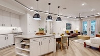 Located in Austin's vibrant 78704 neighborhood, this thoughtfully designed 2-bedroom, 2-bathroom residence offers a seamless open-concept layout spread across a single floor. The heart of the home is an inviting kitchen and living area, where a large center island with built-in shelving anchors the space beneath a trio of striking matte black pendant lights. The kitchen features light shaker-style cabinetry with black hardware, stainless steel appliances including a gas range, microwave, and refrigerator, and a clean white tile backsplash — all set atop warm light-wood flooring that flows throughout the unit. The living room benefits from a tray ceiling detail and French doors that invite natural light and provide outdoor access. Both bedrooms are well-proportioned, offering ceiling fans, natural light through windows with draping, and light-wood flooring. The primary bedroom includes a dedicated walk-in closet with a full adjustable wire shelving system for generous organization. The bathrooms are finished in crisp white tile, maintaining a clean, modern aesthetic. This residence combines functional layout with contemporary finishes to deliver a comfortable and stylish living experience in one of Austin's most sought-after zip codes.