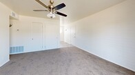 Located at 358 E Roeser Rd in Phoenix, AZ, this single-floor unit offers three bedrooms, one bathroom, and a hallway, all thoughtfully arranged within a compact but functional layout. The living and kitchen area features wood-look flooring, warm wood cabinetry, a white electric range, and light countertops, creating a practical and welcoming common space. Vertical blinds allow natural light to filter through while maintaining privacy.

The generously sized primary bedroom stands out as the largest room in the unit, offering ample space and featuring painted brick accent walls, plush carpeting, a ceiling fan with light fixture, and multiple closets — including a set of double bifold doors — providing excellent storage. The two additional bedrooms are similarly appointed with carpet flooring, painted brick walls, ceiling fans, and windows dressed with vertical blinds that invite natural light.

The bathroom is clean and functional, featuring a tiled tub-and-shower combination with warm beige wall tiles, a white vanity, and a window above the tub for natural ventilation. Throughout the unit, the consistent use of white-painted brick walls, neutral carpet tones, and ceiling fans creates a cohesive, low-maintenance aesthetic well-suited to the Phoenix climate.