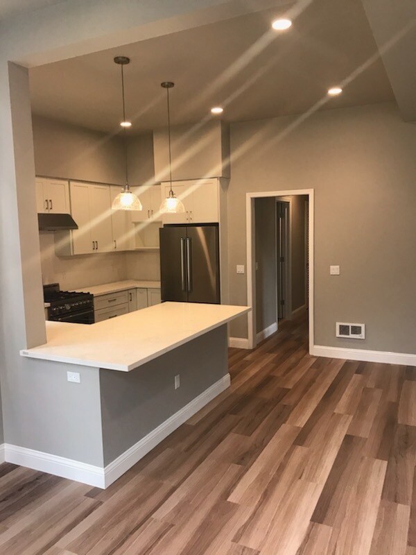 The kitchen and hallway leading to the bedrooms and living spaces. - 894 22nd St