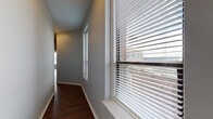 Located at 330 W 4th Street in downtown Cincinnati, Ohio, this single-floor unit offers a thoughtfully designed layout with consistent finishes throughout. Rich, dark hardwood-style flooring runs across the living, dining, and bedroom areas, providing a warm contrast to the neutral gray walls and bright white trim.

The open living and dining area is generously proportioned, filled with natural light from multiple windows fitted with horizontal blinds. A sleek ceiling fan provides both comfort and a modern accent. The space connects seamlessly to the kitchen, which is equipped with stainless steel appliances — including a range, over-the-range microwave, refrigerator, and dishwasher — complemented by white shaker-style cabinetry and a single-basin sink.

The bedrooms are well-sized, each featuring windows with urban views of the surrounding Cincinnati cityscape and hardwood-style flooring. The hallway linking the rooms is bright, with additional windows that allow natural light to filter through.

Two full bathrooms are present, each finished with white vanity cabinetry, brushed nickel fixtures, a full tub-shower combination, and a large mirror. The overall ambiance is clean, modern, and move-in ready, making this unit a practical and stylish option in the heart of downtown Cincinnati.
