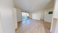 Located at 3761 Harrison Street in Oakland's Temescal neighborhood, this thoughtfully updated single-floor unit offers a clean, modern aesthetic throughout. Light-toned wood flooring flows seamlessly across the entire space, creating a cohesive and airy feel.

The main living area is bright and open, benefiting from a sliding glass door that leads to a private balcony, allowing natural light to fill the room. Vertical blinds offer flexible light control. A wall-mounted heating unit provides efficient climate management.

The galley-style kitchen is well-appointed with white shaker cabinetry, sleek silver hardware, light quartz countertops, and a full suite of stainless steel appliances including a gas range, microwave, refrigerator, and dishwasher.

The bedroom is a calm, neutrally finished space with a large window overlooking the exterior and a full-width mirrored sliding closet that enhances the sense of space. The bathroom features a tub-shower combination enclosed by glass sliding doors, with elegant marble-patterned tile surround lending a refined touch.

Overall, the unit presents a fresh, minimalist design with quality finishes, balcony access, and a functional layout suited to comfortable urban living in Oakland.