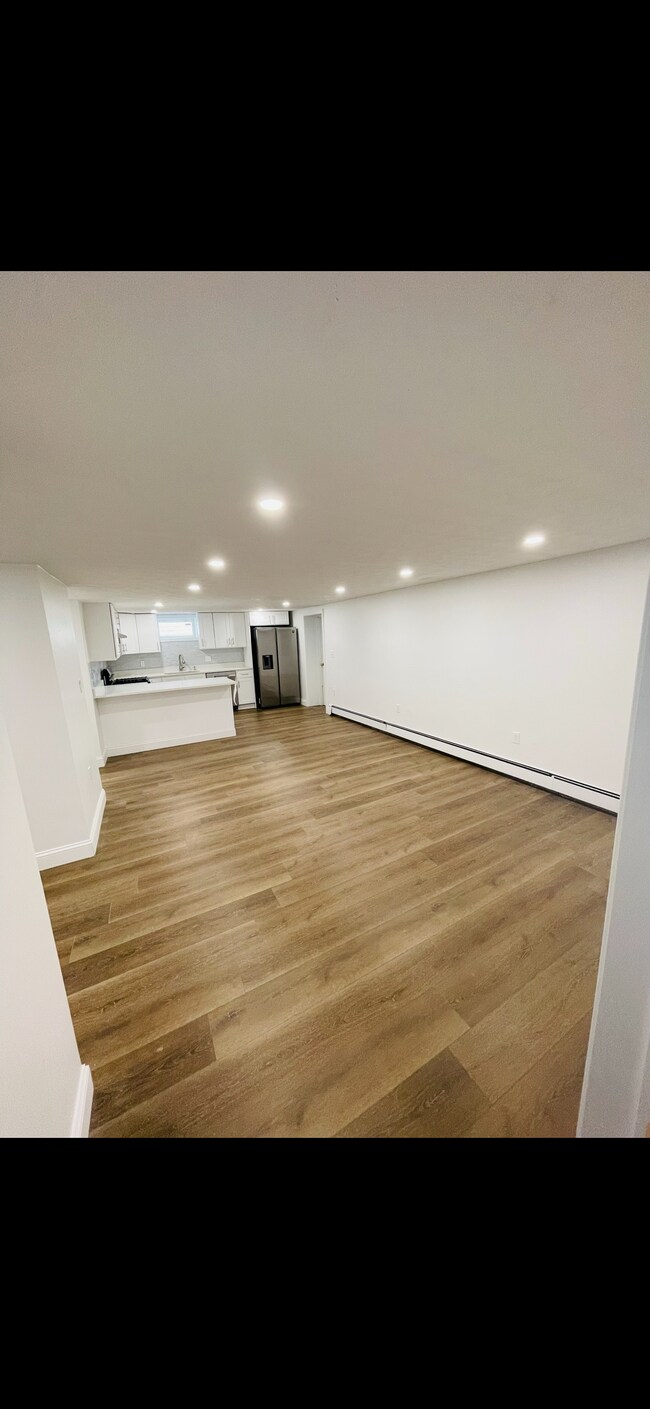 Living room view from Bedroom #1. Main entry door next to refrigerator. - 31 Stowers St