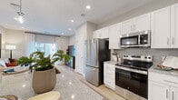Located at 6 Crossgates Rd in Albany, NY, this thoughtfully designed one-bedroom, one-bathroom residence offers a cohesive, modern aesthetic throughout its single-floor layout. The open-concept kitchen and living area serves as the heart of the home, showcasing white shaker cabinetry, granite countertops, a stylish tile backsplash, and a full suite of stainless steel appliances. Pendant lighting over the kitchen island adds a contemporary touch, while light hardwood-style flooring flows seamlessly throughout the space. The living room is bright and welcoming, benefiting from a large window with access to a private balcony that brings in generous natural light. The bedroom offers a comfortable, well-proportioned retreat with a ceiling fan, large window with outdoor views, hardwood-style flooring, and a dedicated closet. The bathroom is finished with a white shaker vanity, granite countertop, a framed mirror, and elegant tile flooring. Neutral gray-toned walls throughout create a calm, cohesive atmosphere that complements the clean, contemporary design. Recessed lighting and quality fixtures complete the polished look of this well-appointed residence.