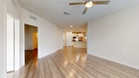 Located at 1223 East Plant Street in Winter Garden, FL, this well-appointed single-story home offers 3 bedrooms, 2 bathrooms, and a thoughtfully designed open-concept floor plan. Light-toned wood-look flooring runs throughout, complementing the clean, neutral palette that gives the home a fresh and modern feel.

The heart of the home is an open kitchen, dining, and living area. The kitchen features white shaker cabinetry, stainless steel appliances including a refrigerator, range, and microwave, a white quartz peninsula with a matte black sink fixture, and stylish black industrial pendant lighting. The adjacent living area is spacious and airy, with a ceiling fan and natural light flowing in from multiple windows.

The primary bedroom is generously sized with a ceiling fan, natural light, and access to a large walk-in closet outfitted with wire shelving systems for ample organization. The additional bedrooms are well-proportioned with wood-look flooring and panel doors. The bathrooms are cleanly finished, with one featuring a tub-shower combo clad in white subway tile and matte black fixtures.

A dedicated laundry room houses a full-size washer and dryer, adding everyday convenience. Additional spaces include a den, pantry, and multiple closets throughout. The home offers a well-balanced combination of functionality and modern style.