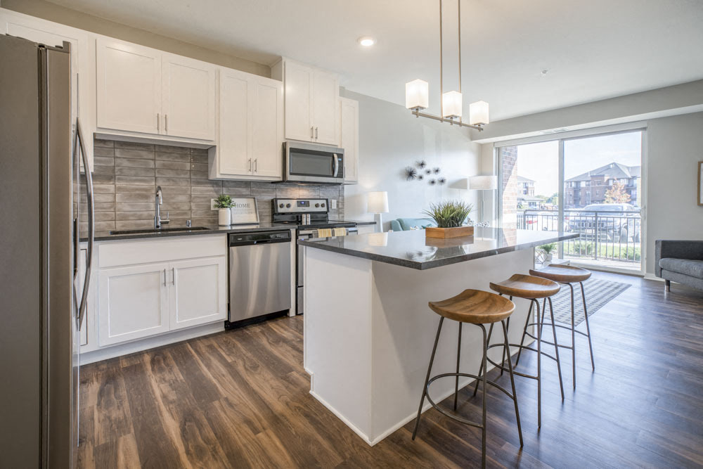 Enjoy a kitchen island with classy pendant lighting. - Ascend at Woodbury