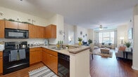 Located in Peoria, Arizona, this single-floor 2-bedroom, 2-bathroom home offers a thoughtfully designed layout that maximizes comfort and functionality. The open-concept kitchen and living area forms the heart of the home, featuring warm wood-toned cabinetry, a peninsula with countertop seating, track lighting, built-in appliances, and an arched decorative niche. Rich hardwood-style flooring flows through the main living spaces, complementing the neutral, light-toned walls throughout.

The living room is generously sized, bathed in natural light from large windows dressed with stylish patterned curtains. The primary bedroom offers a comfortable, carpeted retreat with ample space, large windows, and direct access to its private ensuite bathroom, which includes a vanity with wood cabinetry, a soaking tub, hardwood-style flooring, and a walk-in closet with wire shelving. The second bedroom is equally bright, sharing access to a second full bathroom with similar finishes. Each bedroom benefits from dedicated closet space. A connecting hallway ties the layout together efficiently, making this home a practical and inviting residence in the Peoria area.