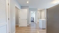 Located at 60 Maple St in Branford, Connecticut, this well-appointed one-bedroom, one-bathroom residence offers a thoughtfully designed open-concept layout finished with light hardwood flooring and a soft, neutral color palette throughout. The kitchen is a standout feature, showcasing crisp white shaker cabinetry, white quartz countertops, stainless steel appliances, and a generous peninsula with bar seating — ideal for casual dining or entertaining. The kitchen flows seamlessly into the dining area, which is brightened by a sliding glass door leading to a balcony with outdoor views. The living room is generously sized, filled with natural light from large windows, and equipped with a wall-mounted mini-split HVAC unit. The primary bedroom offers a comfortable, quiet retreat with ample space and access to two closets. The full bathroom features a glass-enclosed walk-in shower, a vanity with storage, and elegant tile flooring. Recessed lighting and clean architectural lines give the space a modern, polished feel, while the consistent hardwood-style flooring ties each room together cohesively. This residence combines functional design with contemporary finishes for comfortable everyday living.