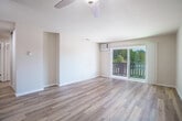 Located at 1038 Second St in Lafayette, CA, this single-floor, 3-bedroom, 2-bathroom home offers a clean, modern aesthetic with thoughtfully updated finishes throughout. Light-toned hardwood-style flooring runs through the main living areas, complemented by neutral walls and ample natural light. A central hallway connects the key areas of the home, leading to a bright living room with sliding glass doors that open to a private balcony with verdant outdoor views.

The kitchen is well-appointed with white shaker cabinetry, dark countertops, stainless steel appliances including a refrigerator, dishwasher, and range, plus a window with natural light and views of surrounding greenery. The living area features a ceiling fan and generous floor space.

The bedrooms are carpeted and comfortable, with the primary bedroom offering sliding glass door balcony access and a mirrored closet with built-in shelving. Additional bedrooms also feature carpeting and closet storage.

The two bathrooms are updated with hardwood-style flooring and dark countertops. One features a tub-shower combination with marble-style tile surround and a well-lit vanity, while the other includes a glass-enclosed standing shower. The home also includes two dedicated closets for additional storage.