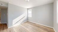 Located at 1603 Roane St in Richmond, Virginia, this single-floor unit presents a clean, modern aesthetic throughout its thoughtfully updated interior. The layout flows in a long, efficient footprint, as seen in the dollhouse view, connecting multiple rooms with ease.

Each room features light-toned luxury vinyl plank flooring that runs consistently throughout the space, complemented by crisp white baseboards and softly painted gray walls that create a bright, airy atmosphere. Natural light filters in through windows in several rooms, enhancing the open feel of the interior.

The bedrooms are well-proportioned, with some offering closet access via classic six-panel white doors. One bedroom features two doors — ideal for a walk-in closet configuration — while another benefits from a window that invites additional daylight. The consistent neutral palette across all rooms provides a versatile canvas for a variety of interior styles.

The bathroom is finished with a full-size soaking tub and shower combination, complete with chrome fixtures and a clean white surround, offering both function and comfort.

Ceiling-mounted light fixtures and visible HVAC vents throughout speak to the practicality of the space, while the uniform finishes and fresh updates give this home a polished, move-in-ready appeal well-suited for Richmond's Roane Street neighborhood.