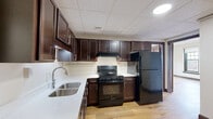 Located at 324 N Vermilion St in Danville, Illinois, this three-bedroom, one-bathroom unit offers a well-proportioned single-floor layout with a cohesive design throughout. Light-toned hardwood floors run throughout the space, complemented by rich, dark wood baseboards and classic panel doors that lend a timeless character to every room.

The three bedrooms are generously sized, with the primary bedroom offering a notably spacious footprint and access to a dedicated closet with a hanging rod. Each bedroom benefits from large multi-pane windows that invite ample natural light and offer views of the surrounding neighborhood. Several rooms feature crown molding, adding an elegant architectural detail, while others display drop-panel ceilings. One bedroom is distinguished by elegant French doors, creating a refined and flexible living space.

The bathroom is clean and functional, equipped with a full tub-shower combination with built-in shelving and chrome fixtures. A hallway connects the rooms, contributing to a practical and efficient flow throughout the unit. A dedicated closet provides additional storage. The neutral wall tones throughout create a bright, open ambiance, making the space feel welcoming and move-in ready. This unit blends classic architectural details with functional living spaces in a well-lit, comfortable setting.