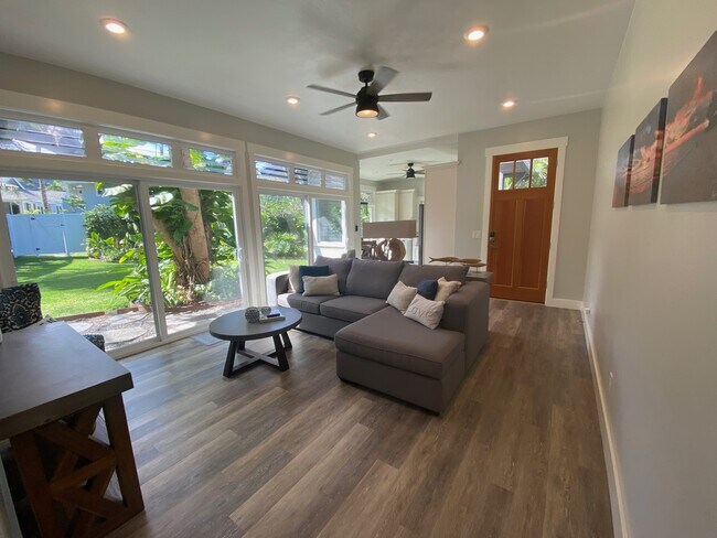 Living Room 1 (1st floor) - 14’ x 18’, sofa with chaise, coffee table, and 50” 4K smart television - 1543 Aalapapa Dr
