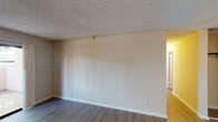 Located at 1035 Aster Ave in Sunnyvale, California, this single-floor unit offers a functional and well-organized layout. The living area features durable hardwood-style flooring, neutral beige walls, and a textured ceiling, creating a clean and versatile space. A dedicated entry door opens directly into the main living zone, providing a clear separation between the interior and the outside.

The galley-style kitchen is efficiently designed with warm wood cabinetry lining both sides, white countertops, a stainless steel sink, a dishwasher, an electric range, and a refrigerator. Light vinyl flooring and overhead lighting keep the kitchen bright and practical.

The bedroom is finished with plush wall-to-wall carpeting, a large window that invites natural light and outdoor views, and a baseboard heating unit. The neutral color palette throughout provides a calm, move-in-ready atmosphere.

The bathroom includes a full-size tub and shower combo with clean white surroundings, light wood-style flooring, a vanity with wood cabinetry, and towel bar fixtures. The overall design of the unit is straightforward and functional, with consistent warm-toned walls and ample outlets throughout, making it a practical home base in the heart of Sunnyvale.