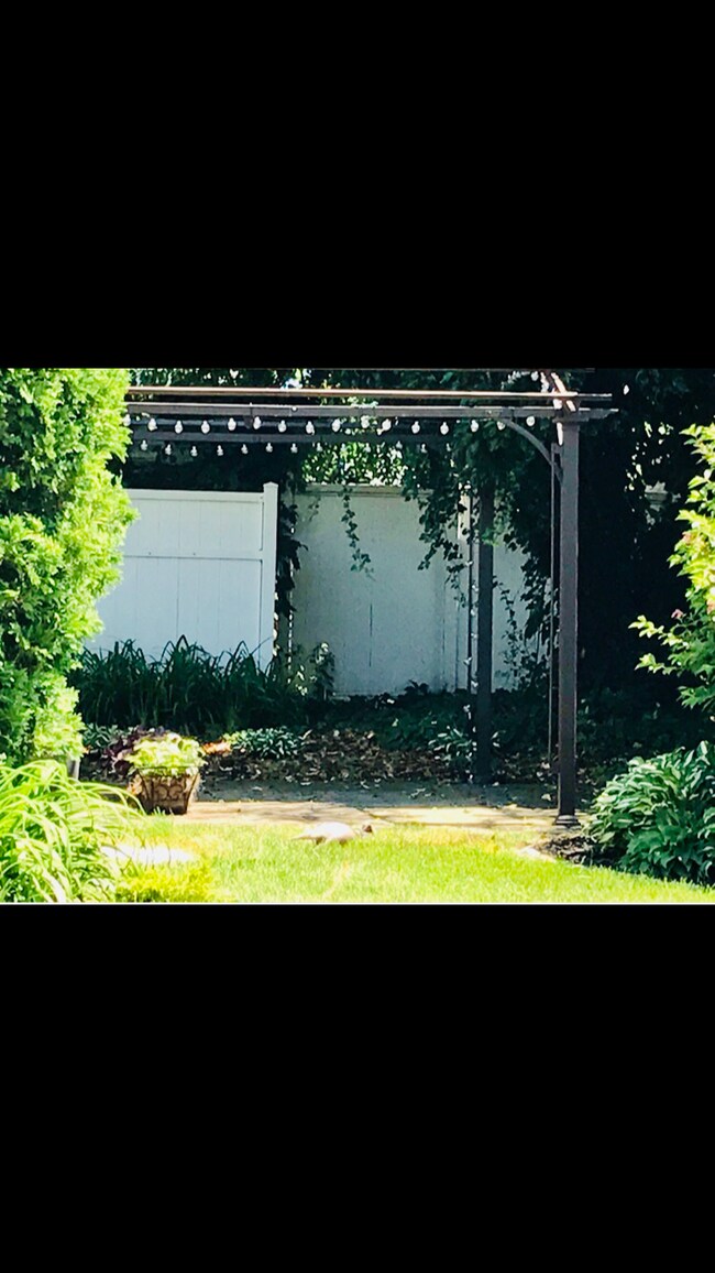 Or enjoy your private backyard garden, patio and pergola. Annual spring and fall landscape services are included in the rental price. - 509 Kahkwa Blvd