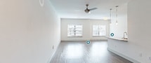 This contemporary 960 square foot apartment offers a thoughtfully designed living space. The open-concept layout seamlessly integrates the kitchen, living, and dining areas, creating a spacious feel. The kitchen is a highlight, boasting granite countertops, stainless steel appliances, and ample cabinet space. Pendant lighting adds a touch of elegance.

The bedroom, measuring 150 square feet, is generously sized and features large windows that flood the space with natural light. The bathroom is modern and functional, with clean lines and a neutral color palette. An in-unit laundry area with a top-loading washer adds convenience to daily life.

Throughout the apartment, light-colored wood-look flooring creates a warm, inviting atmosphere. The living areas are bright and airy, with multiple windows offering views of the surrounding area. Recessed lighting and ceiling fans contribute to the overall comfort and ambiance.

Storage solutions are integrated throughout, including closet space and overhead shelving in the laundry area. The neutral color scheme of whites and light grays provides a blank canvas for personalization. This well-designed apartment combines functionality with modern aesthetics, offering a comfortable and stylish living environment.