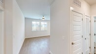 Located in Garland, TX, this well-appointed single-story, 2-bedroom, 2-bathroom home blends modern finishes with a clean, functional layout. Warm wood-look flooring flows consistently throughout the entire space, creating a cohesive and inviting atmosphere.

The open-concept kitchen and living area serves as the heart of the home. The kitchen is outfitted with stainless steel appliances, including a refrigerator, range, microwave, and dishwasher, complemented by two-tone cabinetry, a classic subway tile backsplash, granite countertops, and a central island — ideal for casual dining or food preparation. Recessed lighting illuminates the space, which also benefits from natural light through the windows.

The spacious primary bedroom features a ceiling fan and direct access to a well-organized walk-in closet with built-in shelving and dual hanging rods. Its en-suite bathroom is finished with granite countertops, a single-sink vanity with ample drawer storage, and a glass-enclosed walk-in shower with subway tile surround. A bright window provides natural light.

The second bedroom is generously sized with dual windows, a ceiling fan, and plentiful natural light. Both bedrooms offer a bright, airy feel with neutral wall tones that enhance the clean aesthetic throughout this move-in-ready home.