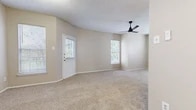 Located in Fort Worth, Texas, this single-story, 2-bedroom, 3-bathroom home offers a practical and comfortable layout with well-defined living spaces throughout. The open living room serves as the heart of the home, featuring neutral-toned carpet, vaulted ceilings, multiple windows with blinds that invite ample natural light, and a sleek black ceiling fan for year-round comfort. The front entry door with a windowed panel adds a welcoming touch to this bright, airy space. The galley-style kitchen is efficiently designed with light wood-look flooring, gray cabinetry, white countertops, and black stainless appliances including a refrigerator, microwave, and range. The primary bedroom is generously sized, featuring plush carpet, two windows for natural light, and a ceiling fan with light fixture. It connects to a bathroom with a gray vanity, white countertop, and a tiled tub-shower combo. The second bedroom also offers comfortable carpeted flooring, a ceiling fan, and a closet with double doors. Three bathrooms in total provide convenience for residents and guests alike. A dedicated laundry room and a hallway complete the functional single-floor layout, making this home a well-rounded option in the Whisper Woods community.