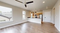 Located at 601 W Spruce St in Perkasie, PA, this thoughtfully designed one-bedroom, one-bathroom unit offers a clean, modern aesthetic across a single floor. The open-concept kitchen and living area serves as the heart of the home, where light hardwood-style flooring flows seamlessly throughout. The kitchen is equipped with stainless steel appliances — including a refrigerator, range, and microwave — complemented by warm wood cabinetry, dark granite-style countertops, and a large central island with pendant lighting overhead. A ceiling fan anchors the living area, which is bathed in natural light from multiple large windows offering neighborhood views. The spacious primary bedroom continues the light flooring and neutral palette, featuring a generous double closet and several windows that bring in ample daylight. The bathroom is clean and functional, finished with a full soaking tub and shower combination, modern fixtures, and light wood vanity cabinetry. A hallway connects the main living spaces and provides access to all rooms. Throughout the unit, recessed lighting, crisp white trim, and a neutral warm-beige color scheme create a bright, cohesive, and welcoming atmosphere.