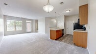 Located at 4684 Lakes Edge in West Chester, OH, this single-floor, one-bedroom, one-bathroom home offers a thoughtfully designed layout that maximizes functionality and comfort. The open-concept living, dining, and kitchen area forms the heart of the home, with plush carpet flowing through the living and dining spaces and wood-look flooring anchoring the kitchen. A central kitchen peninsula with a built-in sink provides both prep space and casual seating, while warm honey-toned cabinetry, granite-look countertops, pendant lighting, and black appliances — including a refrigerator, electric range, and microwave — complete the kitchen. The living room is generously sized, filled with natural light from a large window and a glass-panel door leading to a private balcony. The bedroom is a comfortable retreat featuring a wide window with treetop views, soft carpeting, and access to a spacious walk-in closet fitted with wire shelving. A second closet provides additional storage. The full bathroom includes wood-look tile flooring, a warm wood vanity with stone-look countertops, and a full tub/shower combination. A dedicated laundry area adds everyday convenience to this well-appointed home.