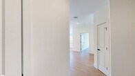 Located at 555 Northfield Avenue in West Orange, NJ, this thoughtfully designed 2-bedroom, 2-bathroom residence offers a generous single-floor layout with a clean, contemporary aesthetic throughout. Light hardwood flooring flows consistently across the living spaces, complemented by crisp white walls and recessed lighting that create a bright, airy atmosphere.

The open-concept kitchen and living area serves as the heart of the home, featuring sleek two-tone cabinetry in navy and white, white quartz countertops, stainless steel appliances including a gas range and built-in microwave, and a matte black sink fixture. A large window in the kitchen brings in natural light and outdoor views.

The spacious primary bedroom is a standout feature, boasting floor-to-ceiling corner windows that frame sweeping outdoor views and flood the room with natural light. The second bedroom also offers comfortable proportions with light-toned flooring and easy hallway access.

Both bathrooms are finished with elegant marble-style tile flooring and walls. The primary bath includes a frameless glass walk-in shower with full-height marble tile surround and matte black hardware accents. A versatile den provides additional flexible living space, while a dedicated laundry room and five closets ensure exceptional storage throughout. A private balcony completes this well-appointed residence.