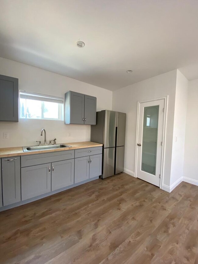 Kitchen has butcher block counters, brand new appliances and a very small pantry. - 9345 Woodley Ave