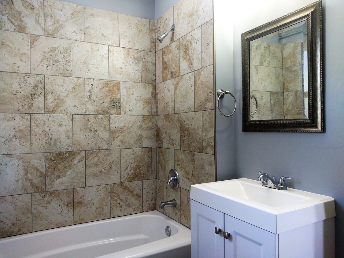 Bathroom complete with porcelain travertine tile with a modern trim kit - 16 Clinton Ave