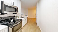 Located at 2426 Thoroughbred Dr in Bowling Green, Kentucky, this one-bedroom, one-bathroom unit offers a well-designed single-floor layout that maximizes every inch of its compact footprint. The open-concept living and kitchen area is bright and welcoming, with light wood-style flooring, white walls, and a ceiling fan that enhances airflow and comfort. Natural light streams in through multiple windows fitted with blinds, creating an airy atmosphere throughout.

The kitchen is thoughtfully appointed with crisp white cabinetry featuring black hardware, a subway tile backsplash, a stainless steel sink, and a full suite of stainless steel appliances including a refrigerator, electric range, built-in microwave, and dishwasher. A peninsula counter adds both prep space and a natural divide between the kitchen and the living area.

The bedroom offers a comfortable, carpeted retreat with a ceiling fan, a window overlooking greenery, and a sliding-door closet providing ample storage. The bathroom is clean and functional, featuring wood-look flooring, a single vanity with a white countertop, and a tiled tub-shower combination accented with a classic black tile border. This unit presents a practical and tidy living space well-suited for those seeking simplicity and convenience in Bowling Green.