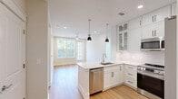 Located at 15228 Statesville Rd in Huntersville, NC, this well-appointed single-floor residence offers three bedrooms and three bathrooms within a thoughtfully designed layout. The open-concept kitchen and living area serves as the heart of the home, showcasing white shaker-style cabinetry extending to the ceiling, stainless steel appliances including a gas range, built-in microwave, dishwasher, and French door refrigerator, along with a large center island topped with crisp white quartz countertops and a undermount sink — illuminated by pendant lighting. Light hardwood flooring flows through the main living areas, adding warmth to the bright, neutral palette. The bedrooms are carpeted and generously sized, each featuring ceiling fans and natural light from large windows. The primary bedroom includes a walk-in closet with built-in shelving and rods. The bathrooms are finished with light tile flooring, white vanities with quartz countertops, and matte black hardware accents. The primary bath features a dual-sink vanity and a tiled shower, while secondary bathrooms include tub-shower combinations with tile surrounds. Clean white walls, recessed lighting, and consistent modern finishes create a cohesive, move-in ready atmosphere throughout.