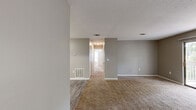 Located in Albany, Georgia, this single-story, 2-bedroom, 2-bathroom home offers a practical and comfortable layout designed for everyday living. The living room greets you upon entry with neutral-toned carpet flooring, soft gray walls, and a front door that brings in natural light — creating a welcoming, open atmosphere. The kitchen is well-equipped, featuring white cabinetry with light granite-style countertops, wood-look vinyl plank flooring, and black appliances including a range and dishwasher, complemented by overhead task lighting. The primary bedroom is generously sized, with plush carpeting, a ceiling fan with light fixture, and a window that allows natural light to filter in. It is supported by a spacious walk-in closet with dual shelving rods for ample organization. The second bedroom also features carpet flooring, a window, and a textured ceiling, making it suitable as a guest room or home office. Both bathrooms include full shower/tub combinations with clean white surrounds and chrome fixtures. Throughout the home, consistent gray-toned walls and white trim create a cohesive, neutral aesthetic, while a mix of vinyl plank and carpet flooring adds functional variety across the living spaces.