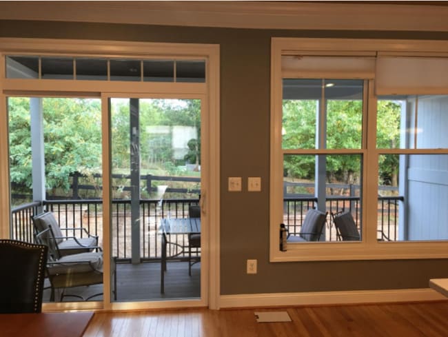 large screened porch opens from kitchen and looks onto a grassy meadow and garden - 1725 Belvedere Plz
