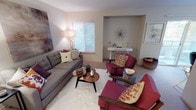 Located at 1015 112th St E in Tacoma, Washington, this single-floor residence offers a thoughtfully arranged layout that balances comfort and functionality. The living room serves as the heart of the home, featuring soft neutral walls, plush carpeting, and natural light streaming through a window with blinds. A built-in alcove provides a dedicated nook ideal for a desk or display area, adding architectural character to the space.

The kitchen is bright and efficient, outfitted with white cabinetry, light countertops, a double-basin sink, and full appliances including a range and refrigerator. Wood-look flooring grounds the kitchen and transitions into the adjacent dining area, which is centered by a round table beneath a ceiling fan with a light fixture. A sliding glass door leads to a private balcony, inviting natural light and outdoor access.

A welcoming entry hallway connects the main living areas to the private quarters, with wood-look flooring providing a clean transition. The bedroom is generously sized, featuring soft carpet, neutral walls, and a window that fills the room with natural light. The full bathroom offers a clean, bright design with a tub-shower combination, wood-look tile flooring, and a white vanity. Overall, the space presents a warm and livable atmosphere throughout.