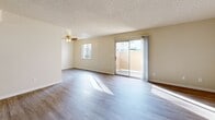 Located at 1301 Richland Ave in Modesto, California, this single-floor residence offers a practical and well-organized layout with three bedrooms, two bathrooms, two living areas, a kitchen, and a connecting hallway. The living room is finished with light wood-look vinyl flooring and features a ceiling fan, a window for natural light, and a sliding glass door that opens to a private outdoor patio. A second living area provides additional flexible space with the same flooring and a front entry door. The kitchen is equipped with white cabinetry, light granite-style countertops, and includes a refrigerator and dishwasher, offering a clean and functional cooking space. Both bathrooms are outfitted with wood-look vinyl flooring, a tub-shower combination, vanity, and neutral warm-toned walls. The three bedrooms are carpeted in a soft gray tone, each with windows that allow natural light and a textured ceiling consistent throughout the home. Warm beige walls provide a neutral canvas across all rooms. The hallway connects the main living areas to the bedrooms and bathrooms, contributing to a cohesive and efficient flow throughout this compact yet well-appointed Modesto residence.