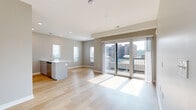 Located on State Line Road in Kansas City, KS, this well-designed 2-bedroom, 2-bathroom residence offers a thoughtful layout with modern finishes throughout. The open-concept living and kitchen area serves as the heart of the home, showcasing light hardwood flooring, recessed lighting, and large sliding glass doors that open to a private balcony with views of the surrounding cityscape. Natural light pours generously into the space, creating a bright and airy atmosphere.

The kitchen is equipped with stainless steel appliances, including a refrigerator, range, and microwave, complemented by white cabinetry, a white tile backsplash, and a spacious island with a built-in sink and white countertops — ideal for both cooking and casual dining.

The primary bedroom features plush carpeting and direct access to its own en-suite bathroom, which includes a sleek, elongated vanity with dark cabinetry, a white countertop, and wood-look flooring. The second bedroom is comfortably sized with soft carpet underfoot and access to a second full bathroom. Each bedroom is served by a dedicated closet, with wire shelving systems providing organized storage. Neutral tones and clean lines throughout give the entire residence a fresh, contemporary feel.