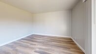 Located at 35 Rosarita Dr in Salinas, CA, this fully renovated 2-bedroom, 2-bathroom unit showcases a clean, modern aesthetic with thoughtful upgrades throughout its single-floor layout. Wide-plank wood-look flooring runs continuously across the entire space, lending a cohesive and contemporary feel.

The galley-style kitchen is a standout feature, equipped with slate-blue shaker cabinetry, matte black hardware, quartz countertops, an undermount sink, and a full suite of stainless steel appliances including a range and refrigerator. The kitchen opens toward the living area, creating a connected and functional flow.

Both bedrooms are well-proportioned, finished with neutral-toned walls and natural light provided by windows with blinds. The primary bedroom includes mirrored sliding closet doors, adding both storage and a sense of depth to the room. The second bedroom also features mirrored sliding closet doors and its own window.

The two bathrooms are stylishly appointed. One features a grey shaker vanity with quartz countertop, wood-look tile flooring, and a full tub-shower combination with a sleek black curtain rod. The other bathroom mirrors the same design language with a matching vanity and warm-toned flooring, maintaining consistency across the unit.

Overall, this unit offers a fresh, move-in-ready living space with modern finishes in a well-organized layout.