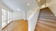 Located at 2745 Clare Ave in Bremerton, WA, this modern 2-bedroom, 4-bathroom multi-level home offers a well-organized layout spread across four floors. The clean, contemporary design is defined by crisp white walls, light hardwood-style flooring throughout the main living areas, and plush carpet in the bedrooms, creating a warm yet refined aesthetic.

The combined kitchen and living area serves as the heart of the home, featuring a sleek galley-style kitchen outfitted with white shaker cabinetry, quartz countertops, a subway tile backsplash, stainless steel appliances, and pendant lighting. Large windows bathe the space in natural light and provide views of the surrounding neighborhood.

The bedrooms are bright and spacious, with large windows and soft carpeting. The primary bedroom includes a walk-in closet with built-in shelving and a dedicated wall-mounted mini-split system for personalized climate control. The four bathrooms are finished with gray tile flooring, wood-toned vanities, and white quartz countertops, maintaining a consistent modern style throughout.

Additional highlights include a private garage with an automatic opener on the ground level, hallways connecting each floor, and a dedicated staircase linking all four levels. The overall ambiance is fresh, clean, and move-in ready.