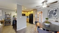 Located at 2860 W Ball Rd in Anaheim, CA, this single-floor, 3-bedroom, 2-bathroom home offers a well-designed layout that maximizes every inch of its living space. The open-concept living room greets you with wood-look flooring, crown molding, and a sliding glass door that fills the room with natural light and opens to a private outdoor patio — ideal for relaxing or entertaining. A stylish kitchen/living room combo connects seamlessly to the dining area, featuring light wood cabinetry, granite countertops, a full suite of black appliances including a refrigerator, range, microwave, and dishwasher, plus a breakfast bar with counter seating. Crown molding and recessed lighting elevate the kitchen's clean, functional aesthetic. The spacious primary bedroom is finished with plush carpeting, crown molding, a ceiling fan, and a bright window, creating a comfortable and restful retreat. The two bathrooms are well-appointed, each with wood-toned vanities and one featuring a tub/shower combo with sliding glass doors. Two additional bedrooms provide flexible space for guests or a home office. A central hallway connects the rooms efficiently. Throughout the home, a cohesive neutral color palette and consistent finishes create a warm, inviting ambiance.