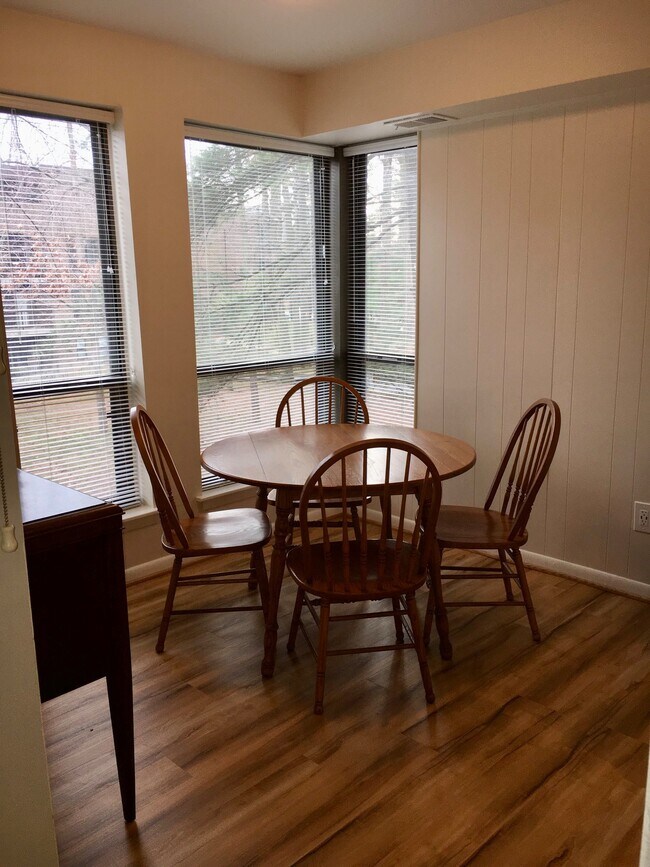 The sunny dining room is fully furnished. All the windows throughout the apartment have relatively new blinds. - 11260 Chestnut Grove Square