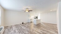 Located at 2880 Majestic Ln in Lafayette, Indiana, this 2-bedroom, 3-bathroom single-floor home offers a clean, modern aesthetic highlighted by light-toned wood-look flooring and a bright, neutral color palette throughout. The open-concept living and kitchen area forms the heart of the home, featuring a ceiling fan with light fixture and natural light from multiple windows. The kitchen is well-appointed with white shaker-style cabinetry, quartz countertops, a center island with pendant lighting, stainless steel appliances including a dishwasher, microwave, and range, and a double sink. The seamless flow between the kitchen and living room makes the shared space feel open and functional. Each bedroom is carpeted with a ceiling fan and closet access; the primary bedroom offers a comfortable, well-proportioned layout with its own dedicated space. The three bathrooms are finished with white vanities, quartz countertops, framed mirrors, and tub-shower combinations. Consistent wood-look flooring and crisp white walls unify the home's interior, creating a cohesive and move-in-ready environment that balances practicality with contemporary style.